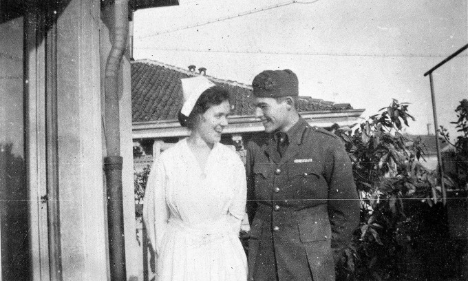 Agnes Von Kurowsky in nursing attire smiles at Ernest Hemingway in a military uniform