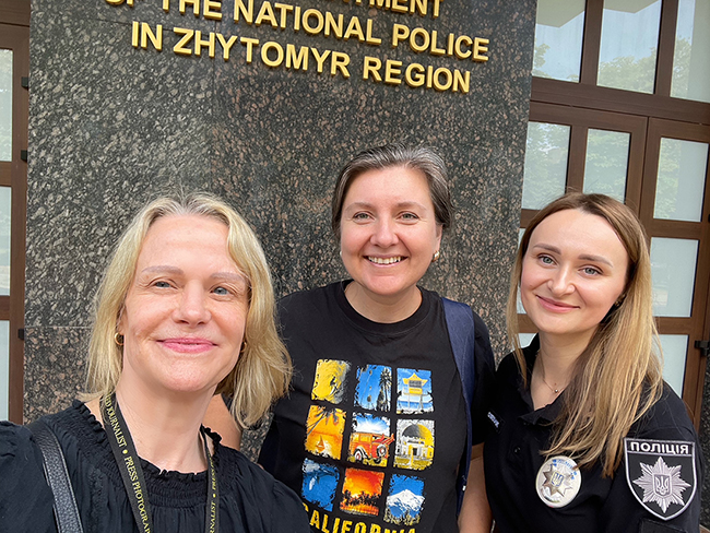 Catherine, Olena, and a female police officer in front of the PD building in Zhytomyr, Ukraine