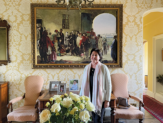 A woman stands in front of a print of Florence Nightingale