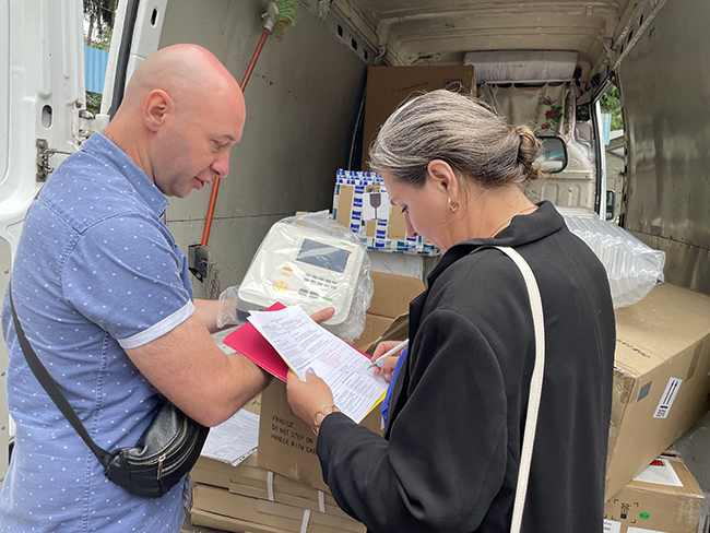 Supplier and Olena audit the equipment being donated to Zhytomyr Hospital.