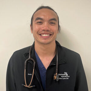 Male nurse wearing scrubs smiling