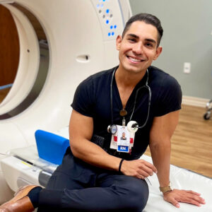 Male nurse wearing scrubs smiling