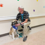 Therapy dog handler in a hospital corridor